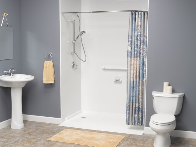 White bathroom with toilet and walk-in shower installation